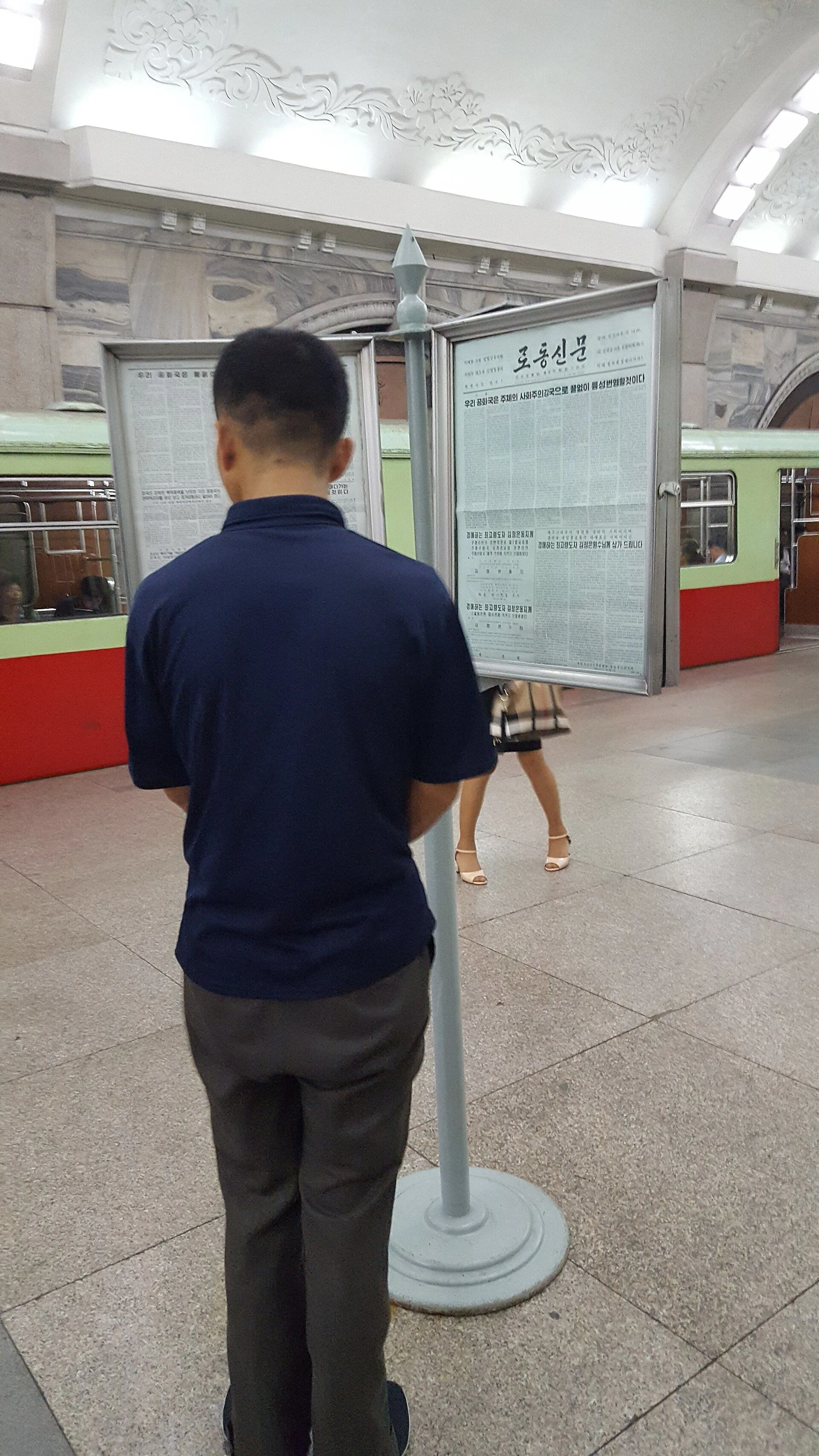 Passenger read Rodong Sinmun in Puhung Station