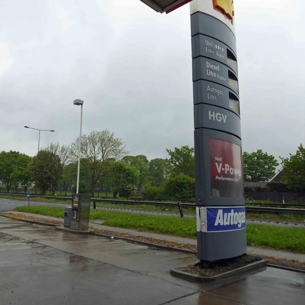 A wet Shell petrol station forecourt alongside the A63 eastbound (geograph 4480995)