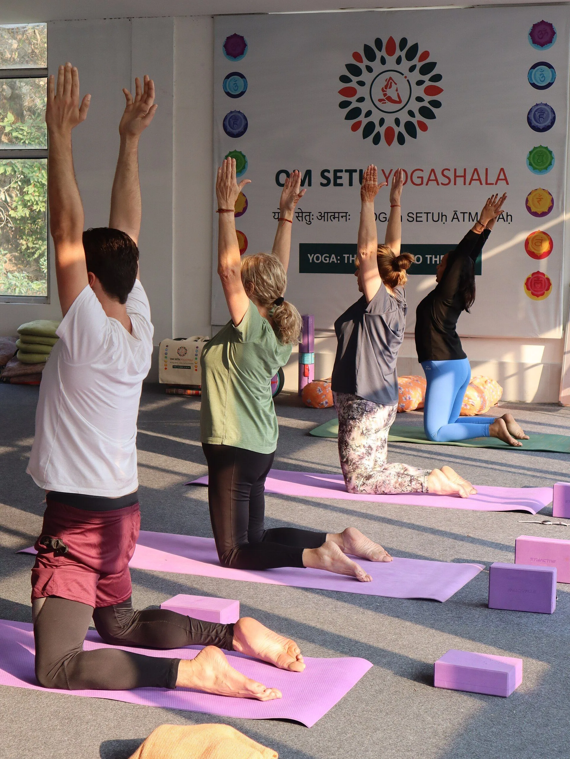 Om Setu Yogashala students practicing asana in Rishikesh yoga hall